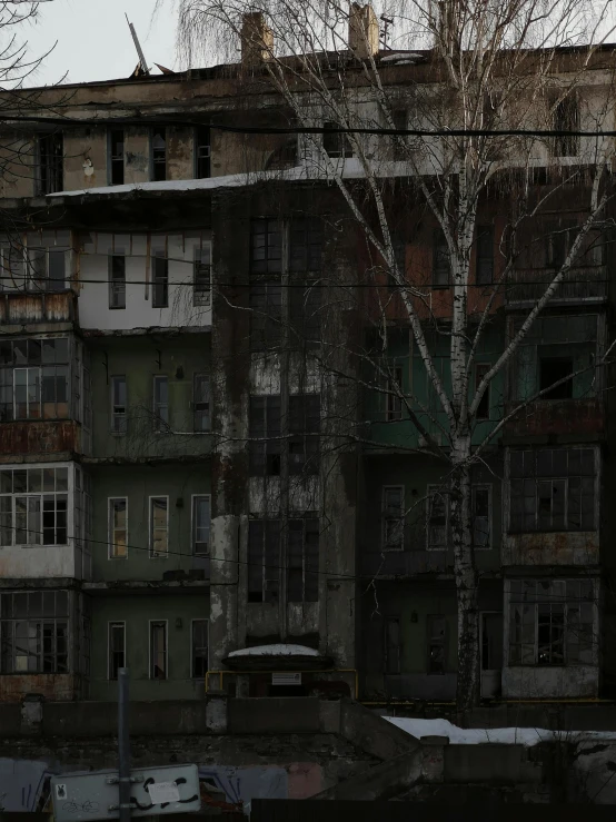 a view from a body of water, looking at a very old building with snow on it