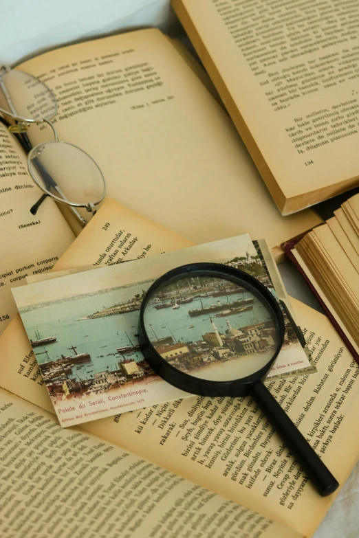 a magnifying glass sits on top of an old book