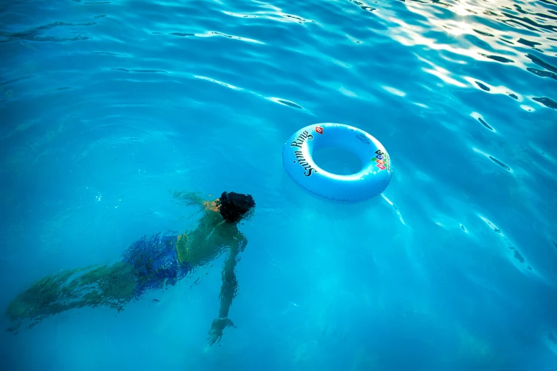 an individual floating on a tube in the water