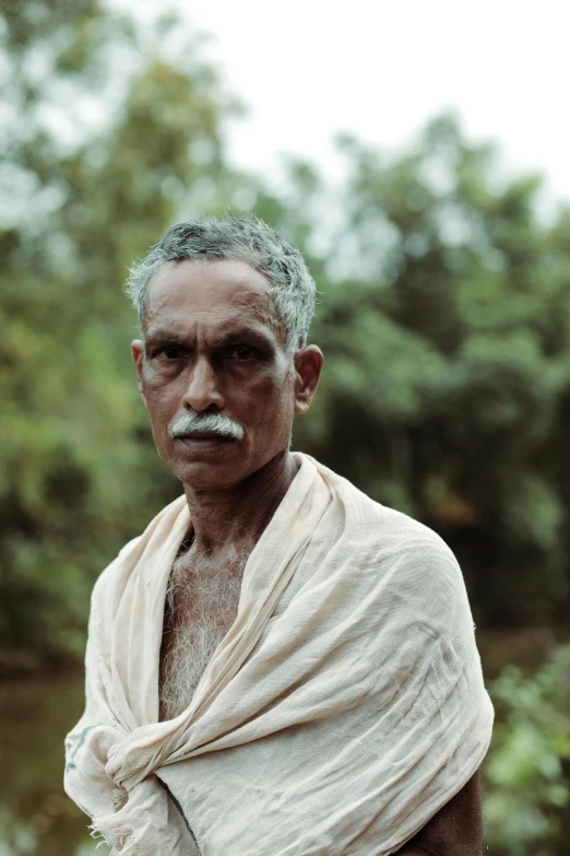 an old man with grey hair and moustache