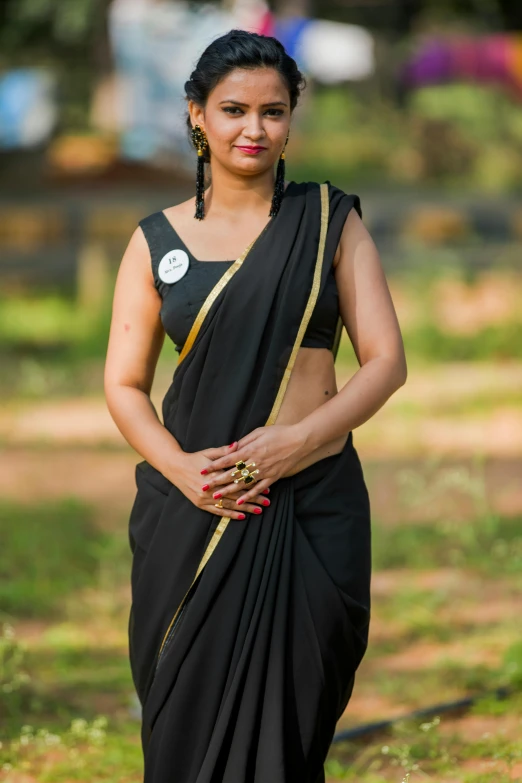 a woman wearing a sari and a ring