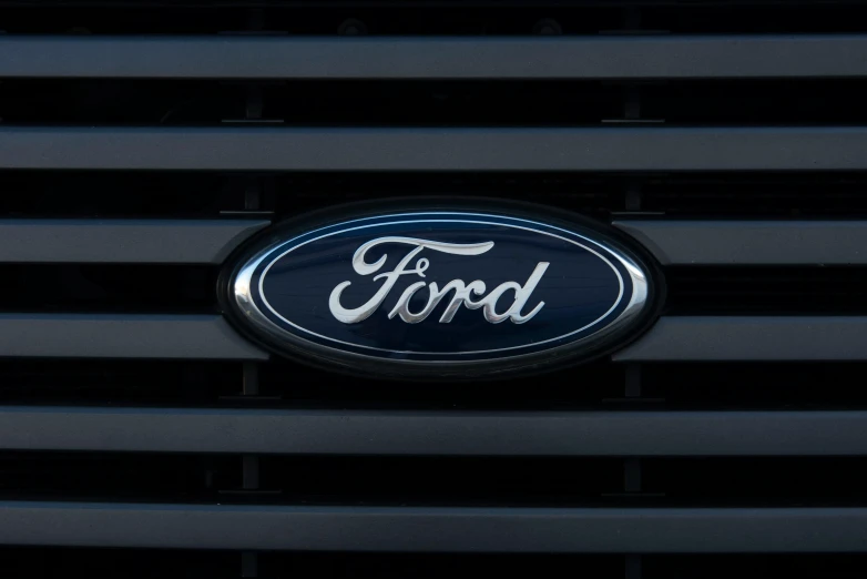 the grille badge on a ford truck that is parked
