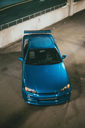 a blue car is parked in an outdoor lot