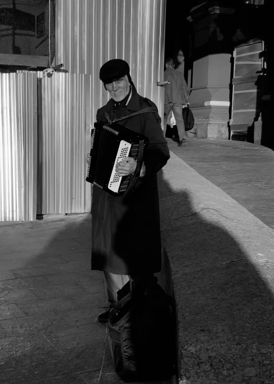 black and white pograph of man with an accordion