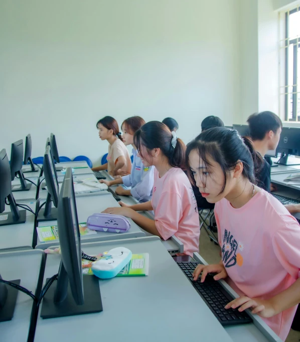 students are working on computers in a row