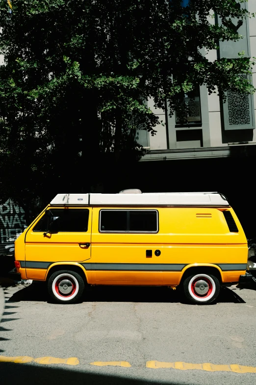 the yellow van is parked next to a motorcycle