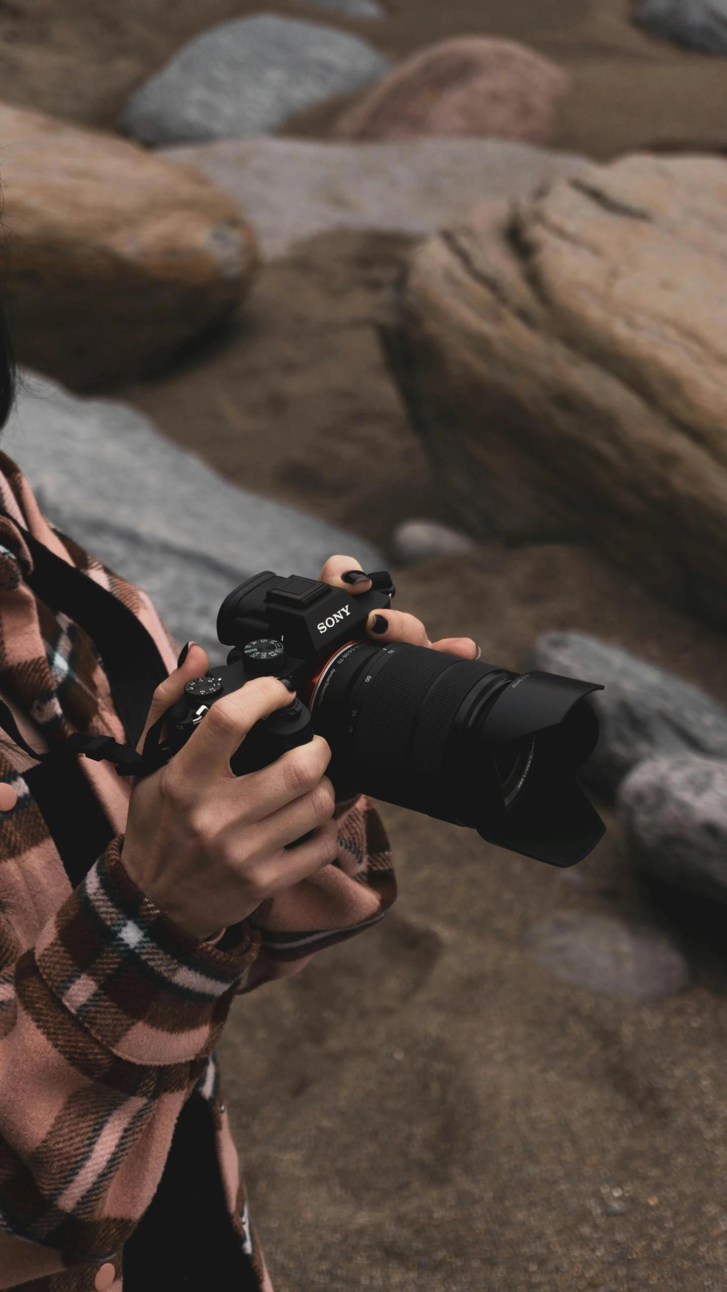 a young woman is holding a camera up to take her picture