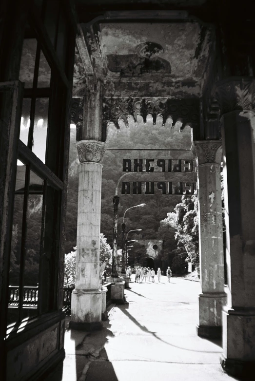 an outdoor area with an archway and a sidewalk