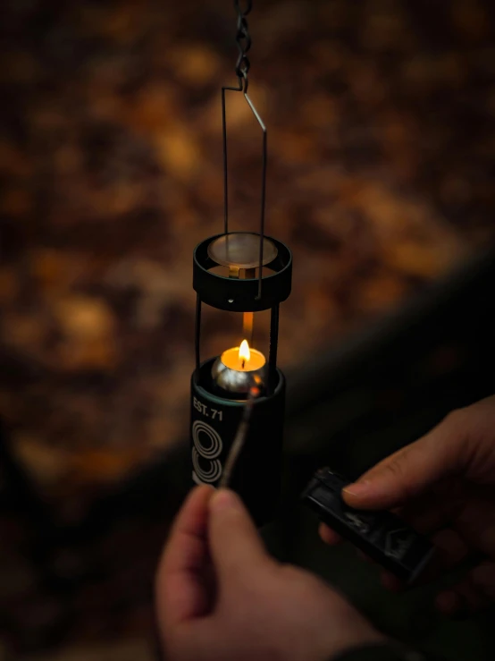 a lighter with the flame on, and someone is holding it