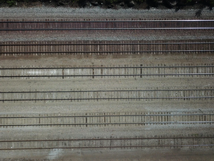 an aerial view of train tracks in the mud