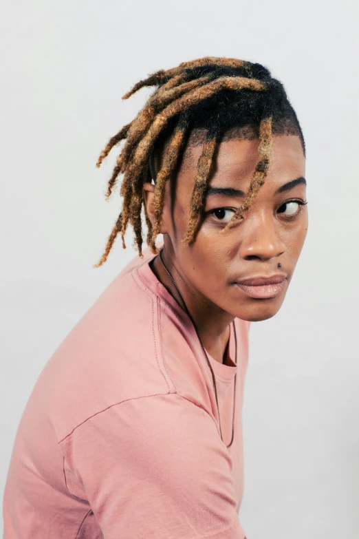 a black woman with dreadlocks looking into the camera