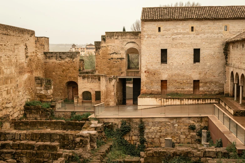 an old brick building with a staircase in front