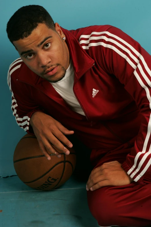 a basketball player posing for a portrait with a basketball