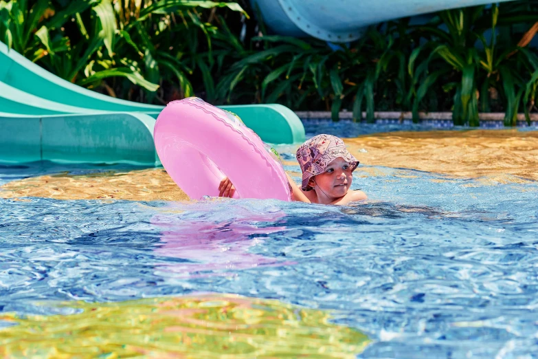 an older woman swimming with a paddle in a pool