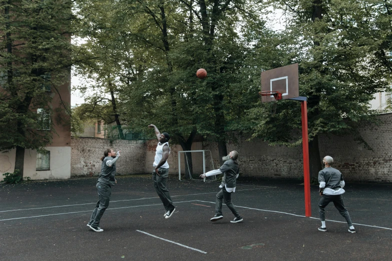 a group of people standing on top of a basketball court