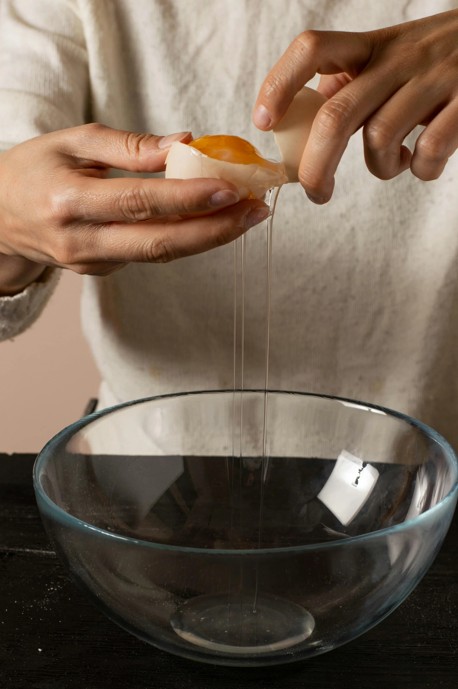 the person is pouring syrup on the food