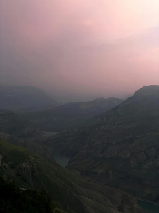 a large hill with some mountains in the background