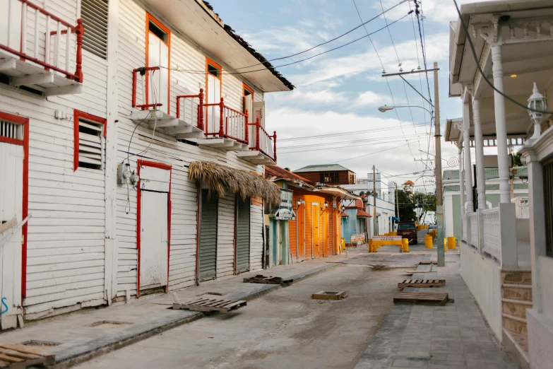 the buildings are painted white and red and the streets have closed down