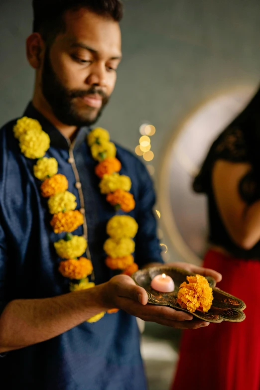 a man wearing a lei is holding food in his hand