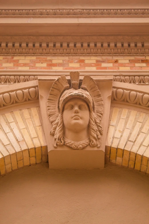 an old church's stone carving showing a face of builder