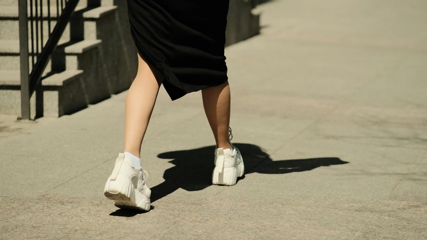 a woman is walking up the steps wearing shoes