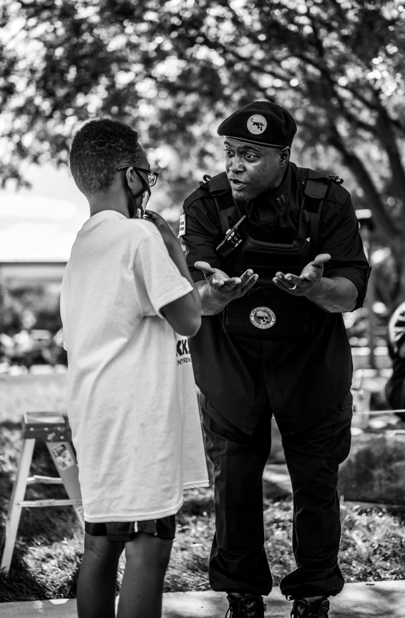 two uniformed men are standing near the sidewalk talking