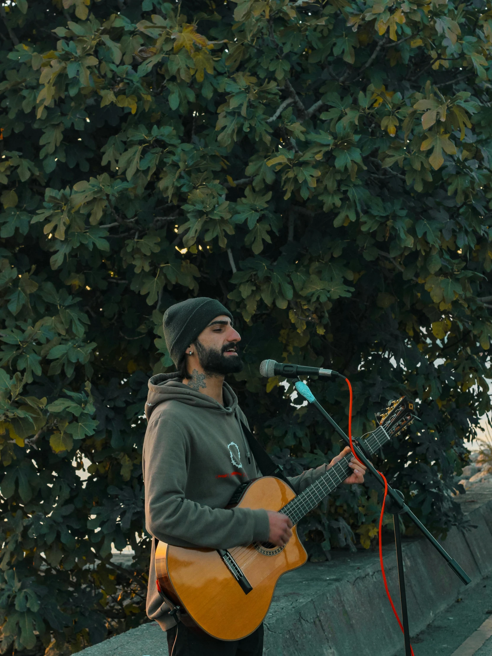 a man holding a guitar and microphone is singing