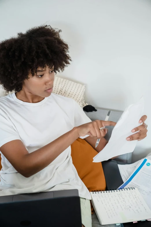 a person is sitting at a table with papers