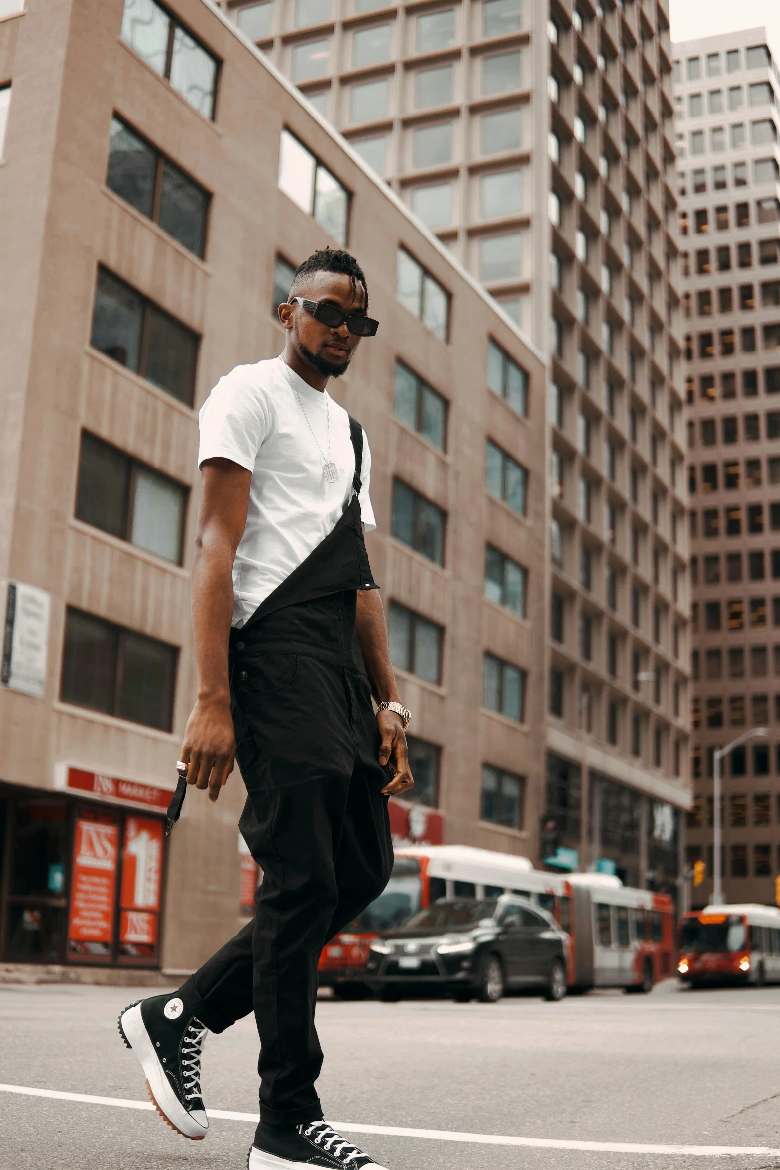 the young man is crossing the street on his skateboard