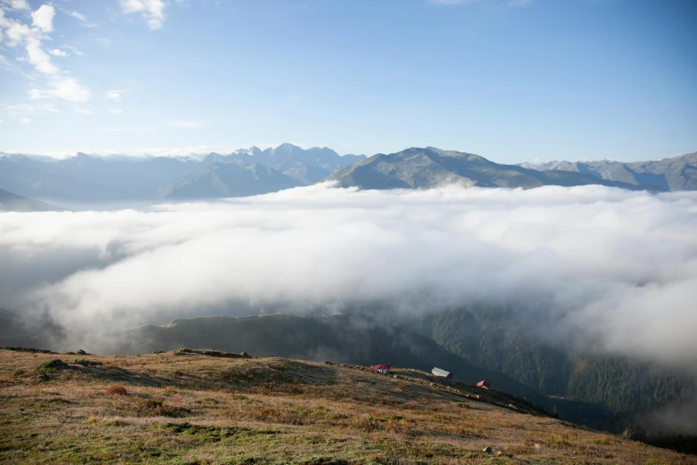 the top of a mountain has low lying fog