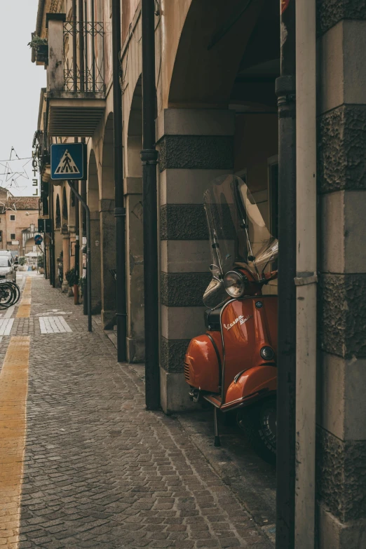 scooter and motorcycles parked on the side of the street