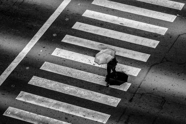 a woman in a white hat and dress walks on a street