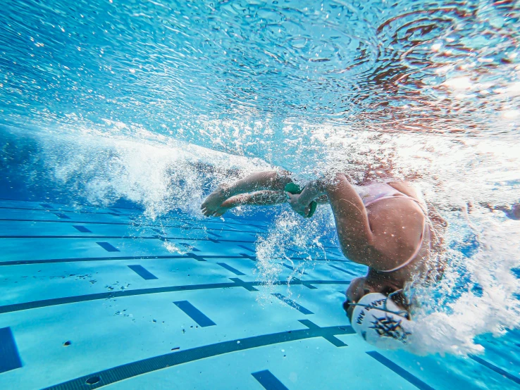 the young swimmer has her head in the water