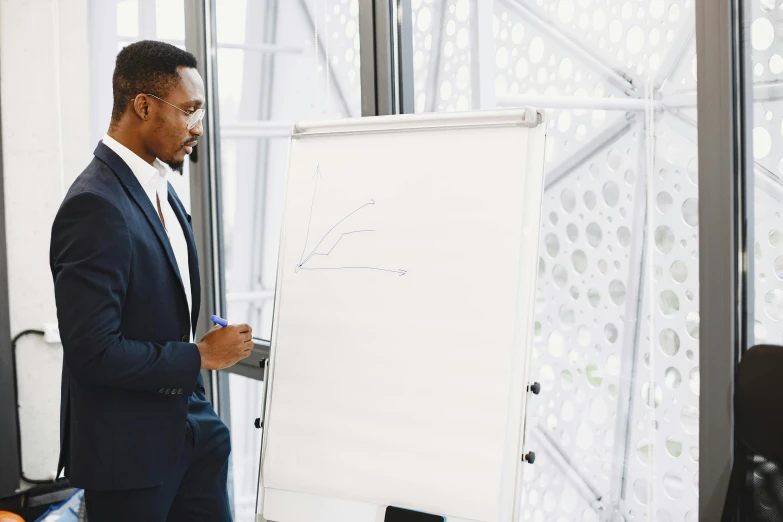 a man in suit in front of a board