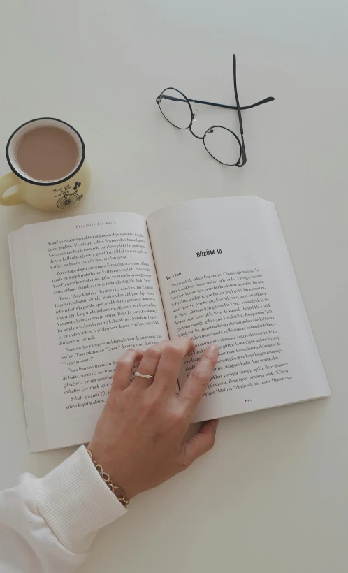 a person's hand holding on to a book