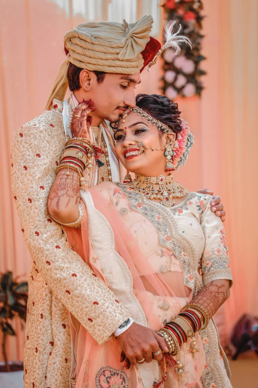 two people dressed up in indian wedding attire