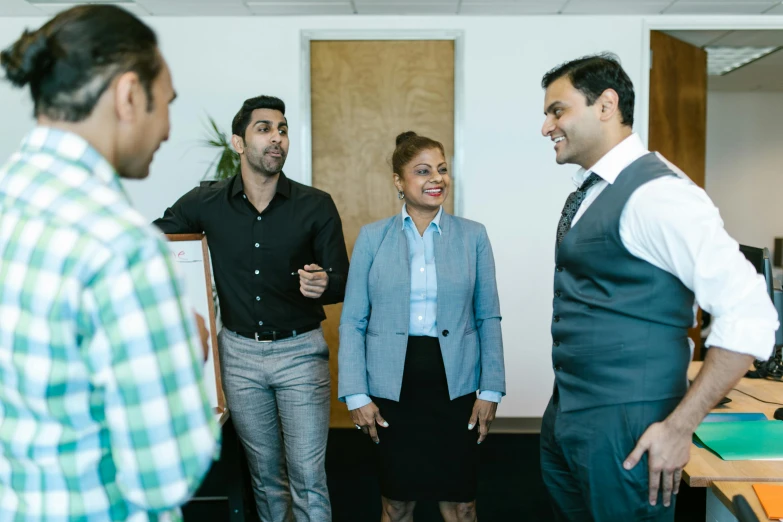 three business people laughing in an office