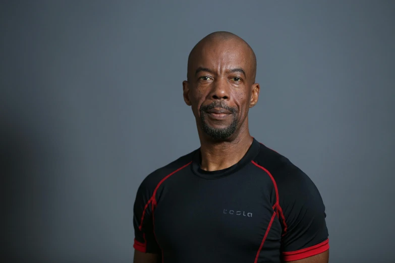 an image of a man in black with red stripes on his shirt