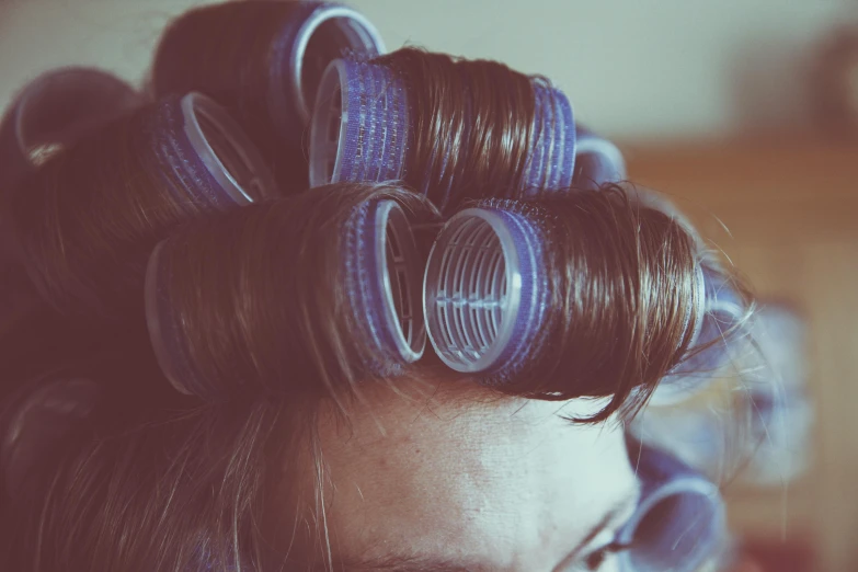 this is a lady's hair with several strands of tape in her hair