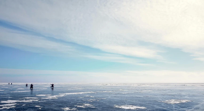 two people are standing on ice on a cold day