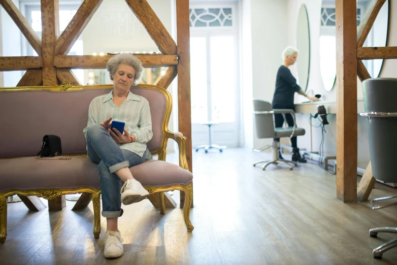 a woman sitting on a couch in front of some tables