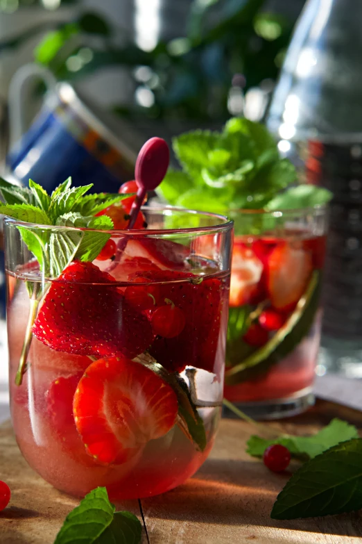 there are glasses with strawberries on the table