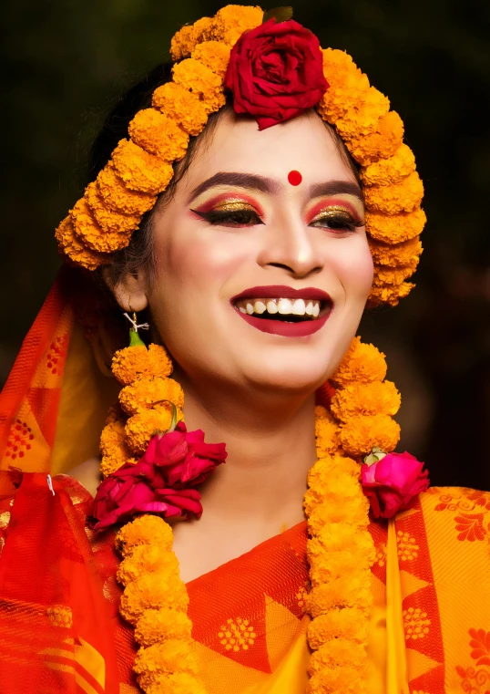 a smiling woman with her face covered by flowers