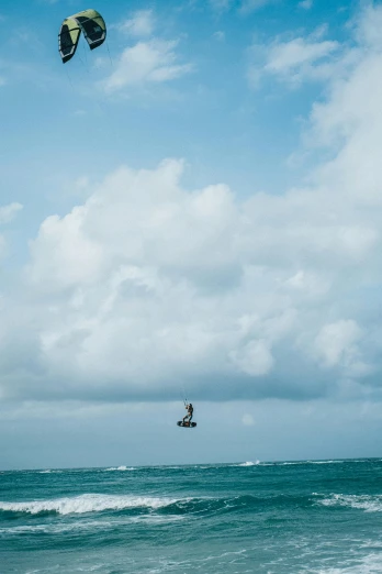 an overcast day and a kite surfer in the ocean