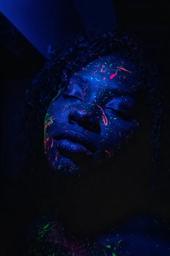 a person with fluorescent colors and face paint