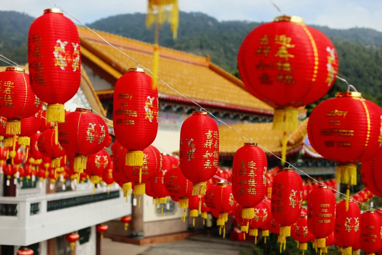 red lanterns hang over a building on a hill