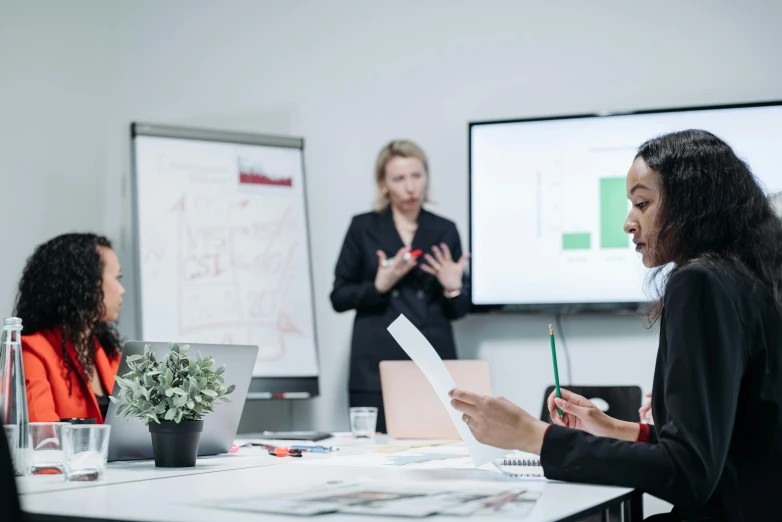 a group of women having a seminar in front of a screen