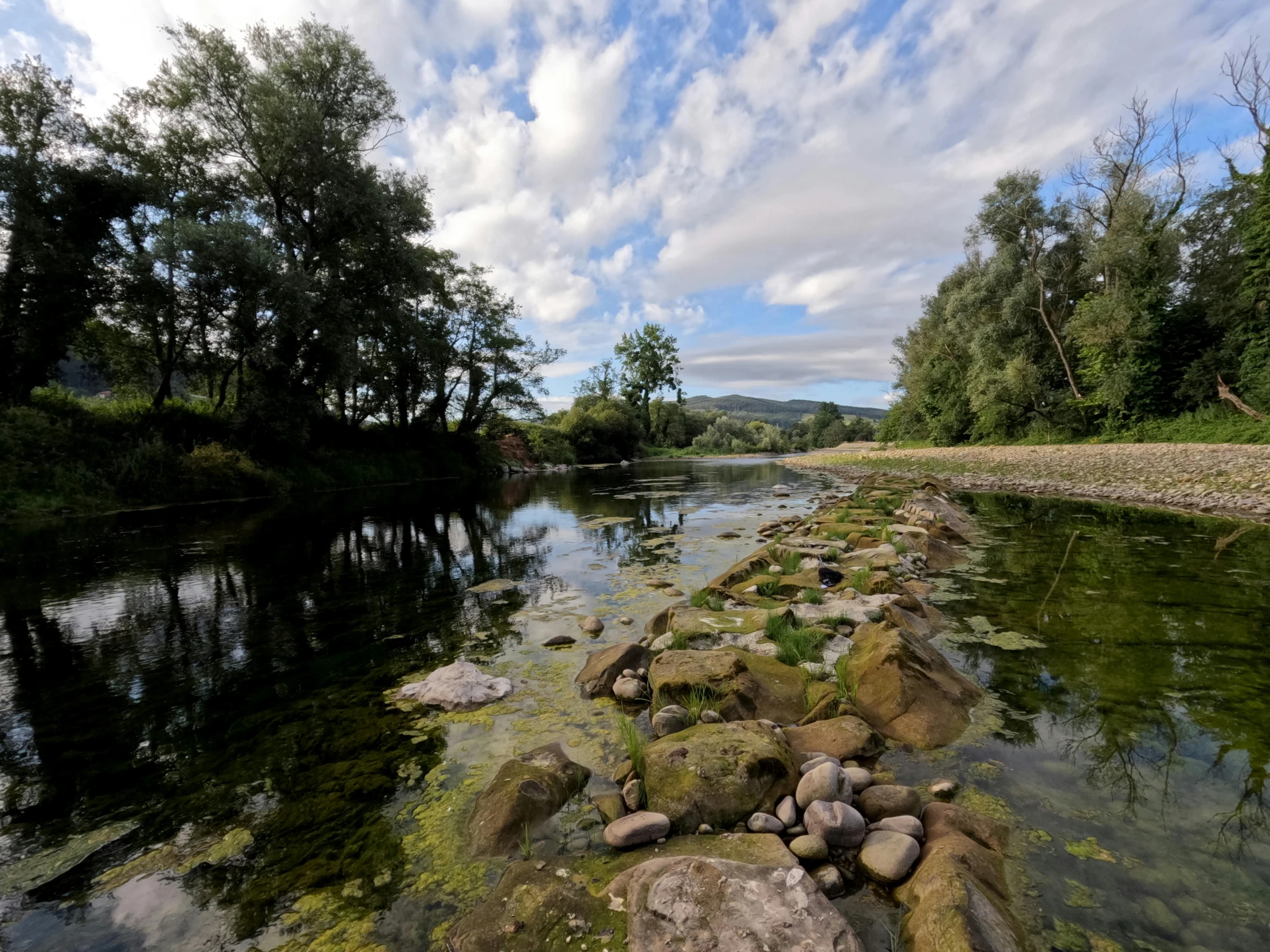 an expanse of land surrounding a small river