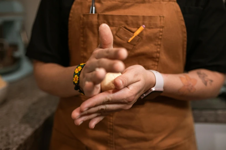 a chef holding a pastry in his hand