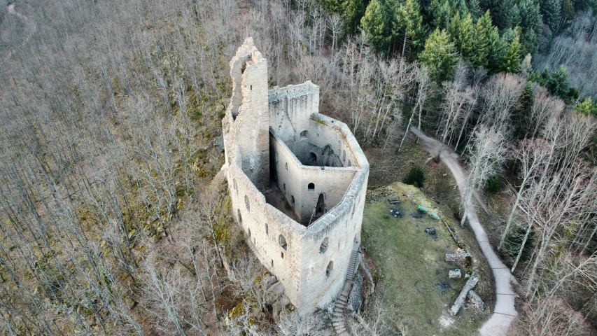 an old tower in the woods with trees